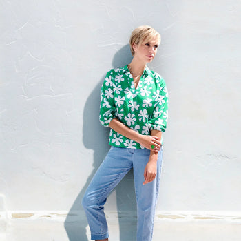 A model waering jeans and a green blouse with a print